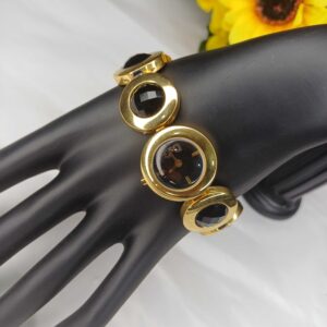 Elegant Gold-Tone Bracelet Watch with Black Gem Accents